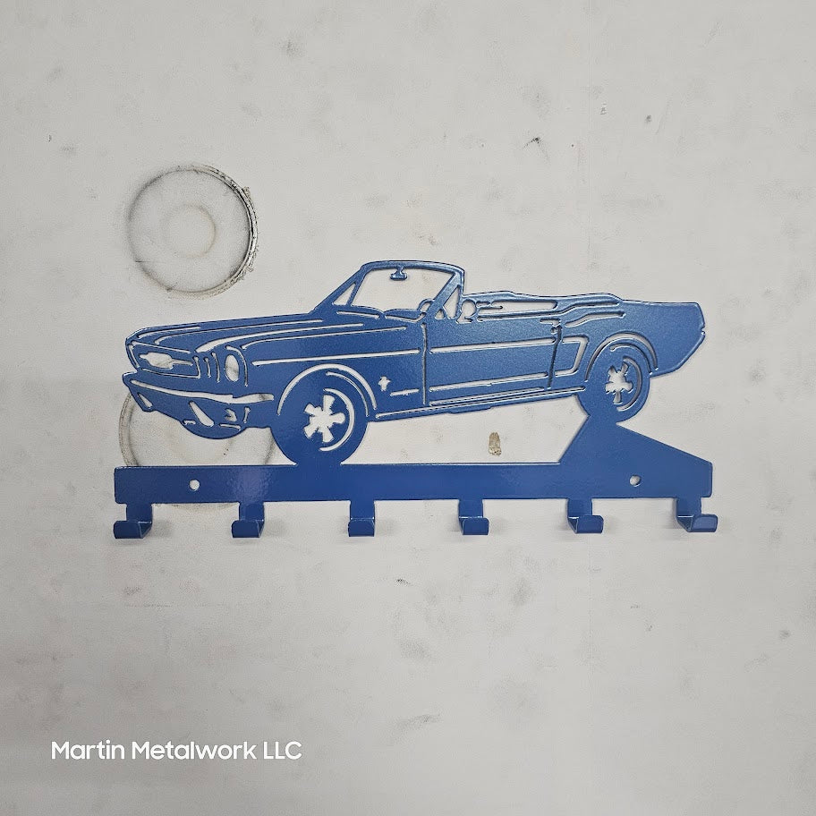 Blue metal car-shaped key holder on a gray background with 'Martin Metalwork LLC' branding.